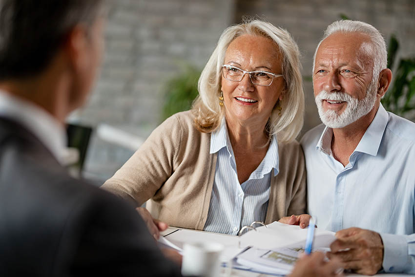 Happy older couple talking about their estate plan and feeling very positive and optimistic